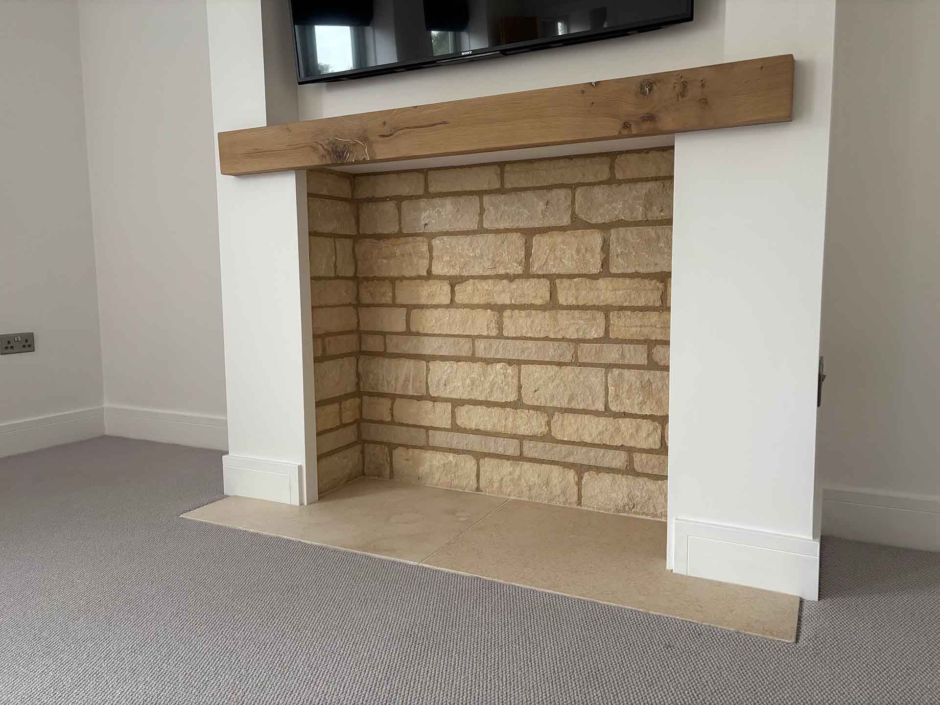 media feature wall, Ancaster stone fireplace, inset tv, led lighting, flush laid limestone tiles