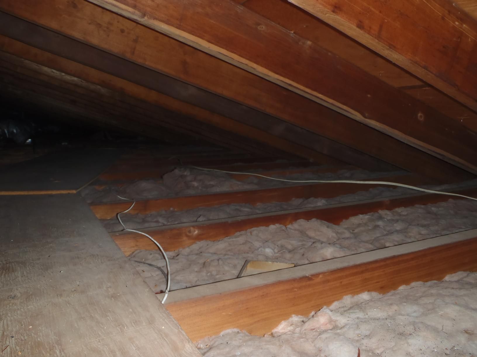 A bathroom with two sinks , a tub , and a large mirror.