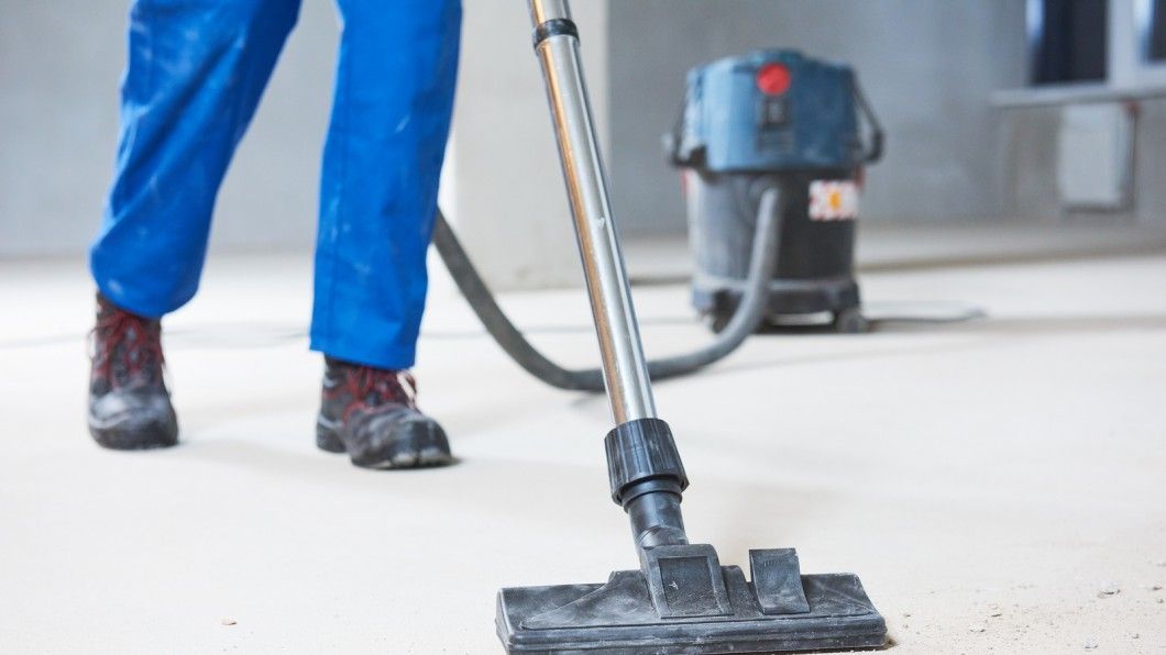 A bathroom with two sinks , a tub , and a large mirror.