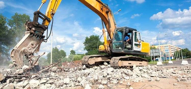 A bathroom with two sinks , a tub , and a large mirror.