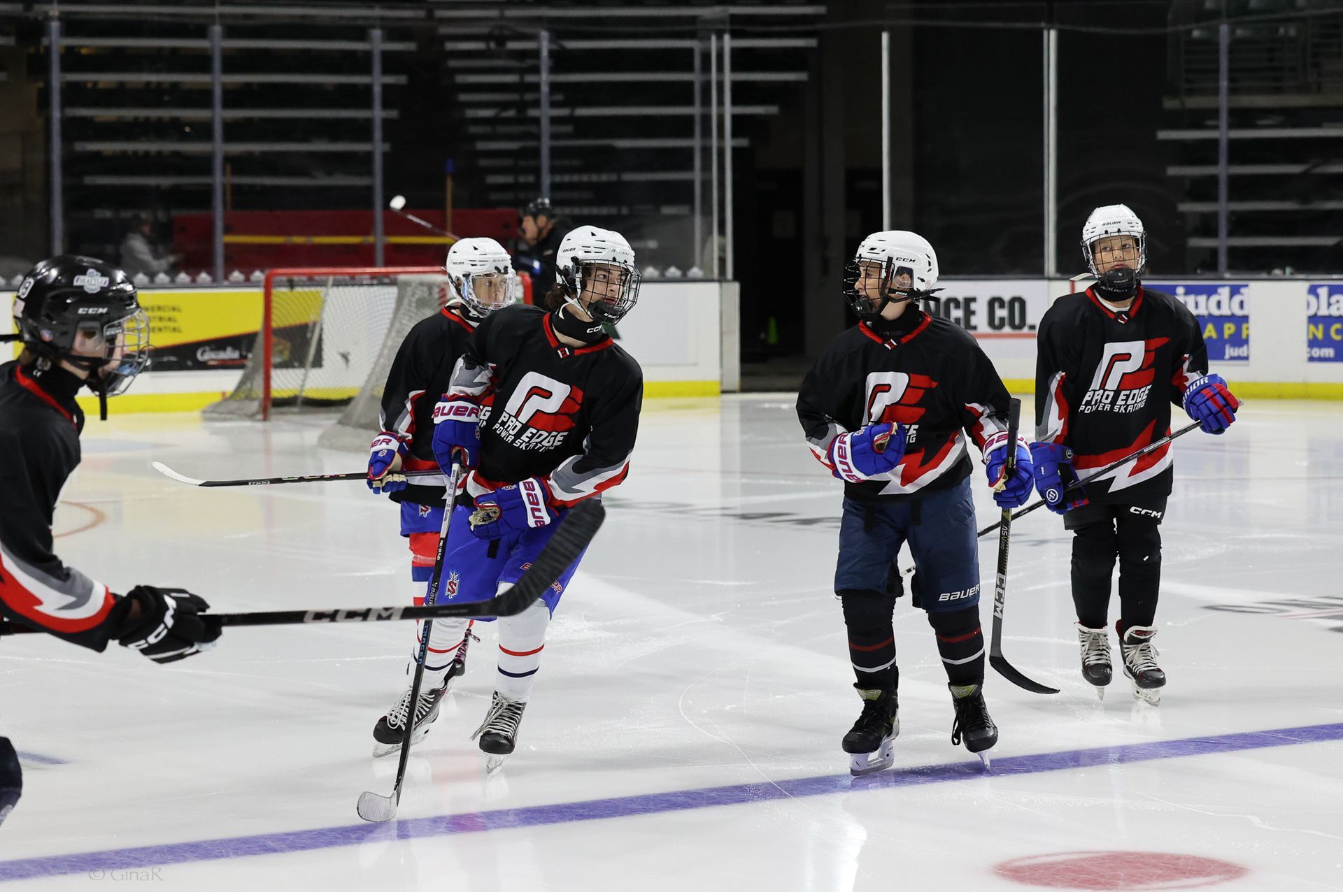 A group of hockey players are playing a game on the ice.