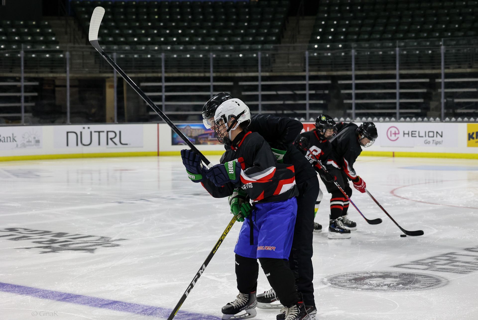A group of hockey players are practicing on the ice.