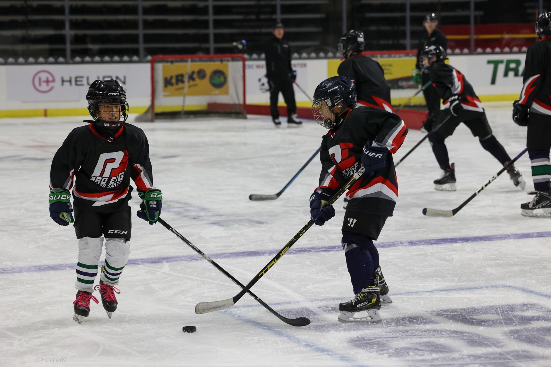 A group of young boys are playing ice hockey on a rink