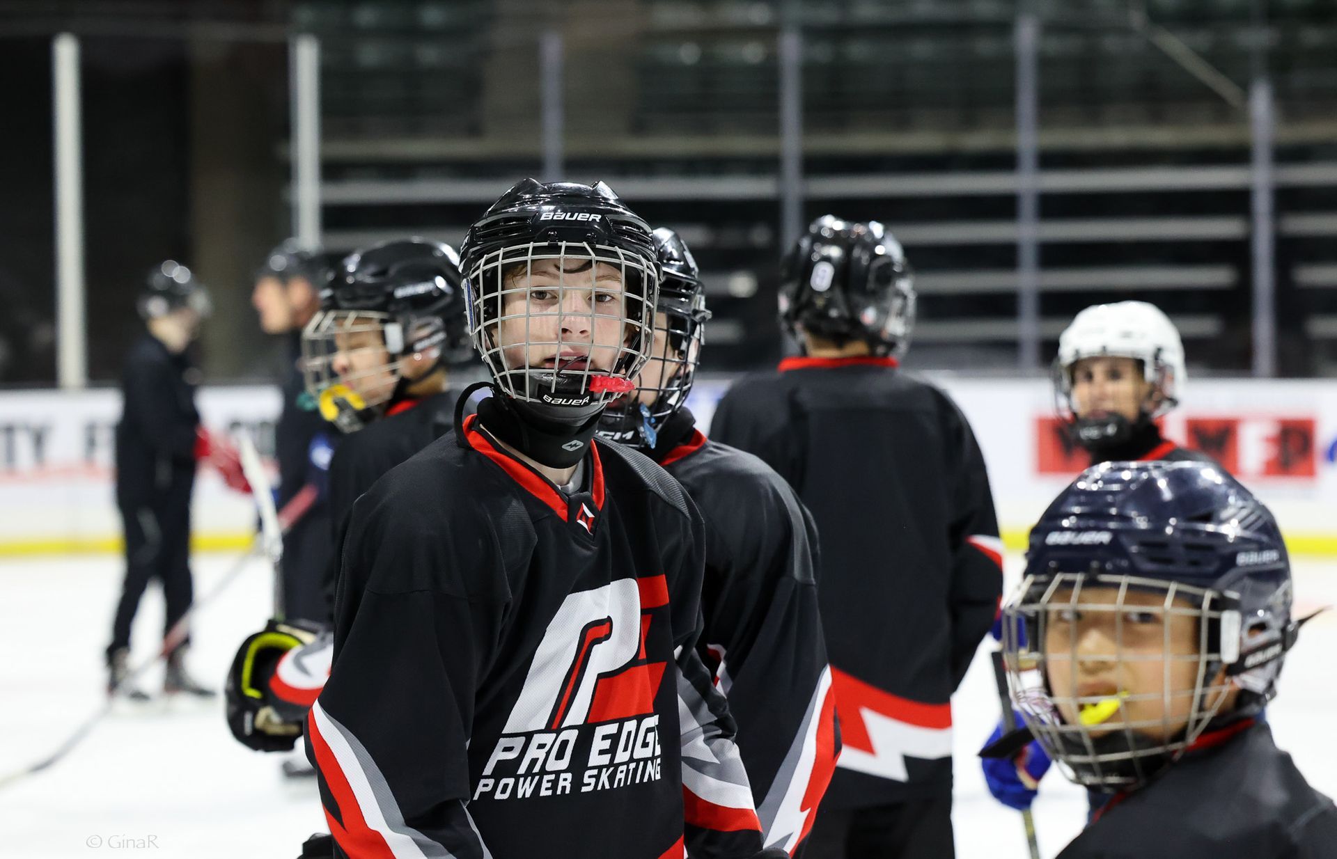 A group of young hockey players are standing on the ice.