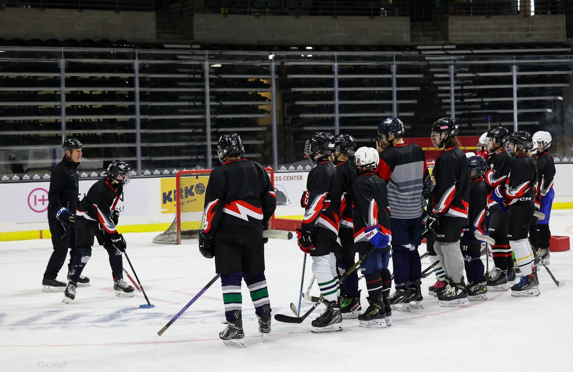 A group of hockey players are huddled together on the ice.