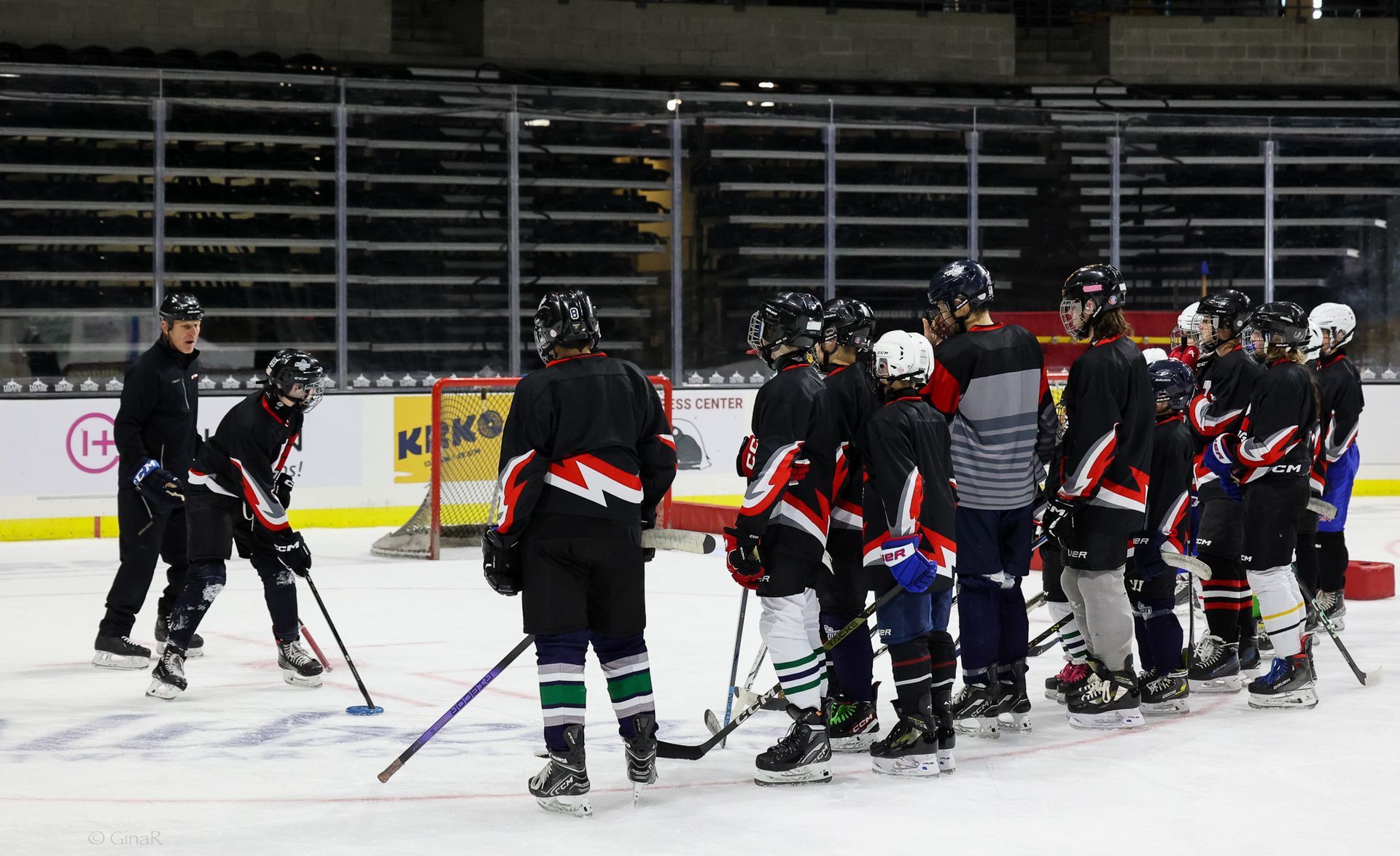 A group of hockey players are huddled together on the ice.
