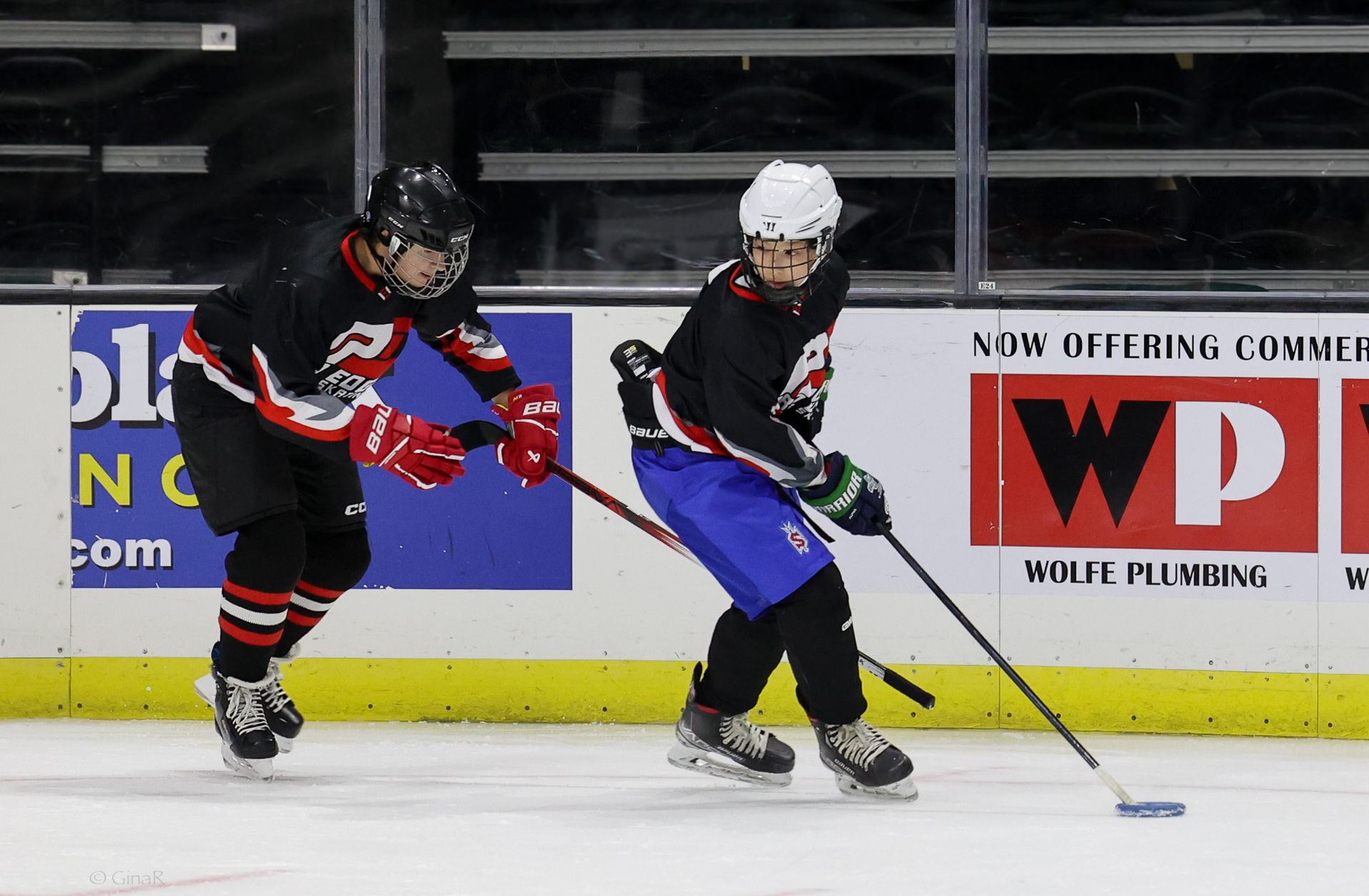 Two young athletes playing ice hockey