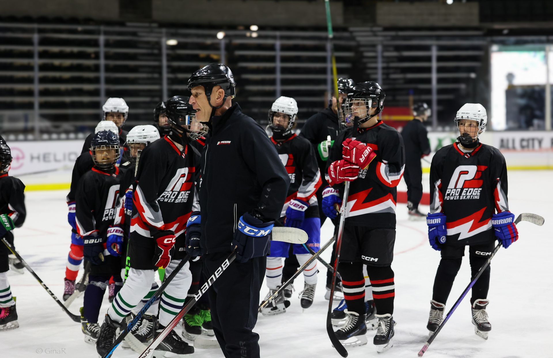 A group of hockey players are standing on the ice.