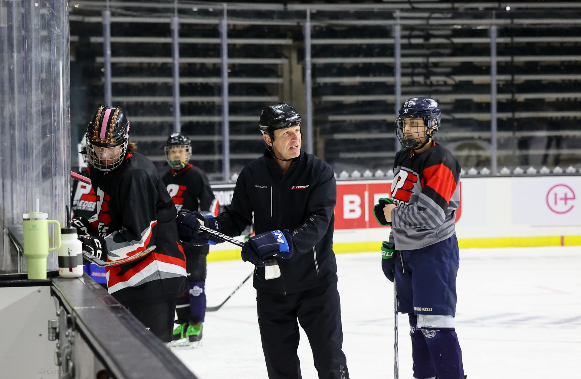 A group of hockey players are standing on the ice.