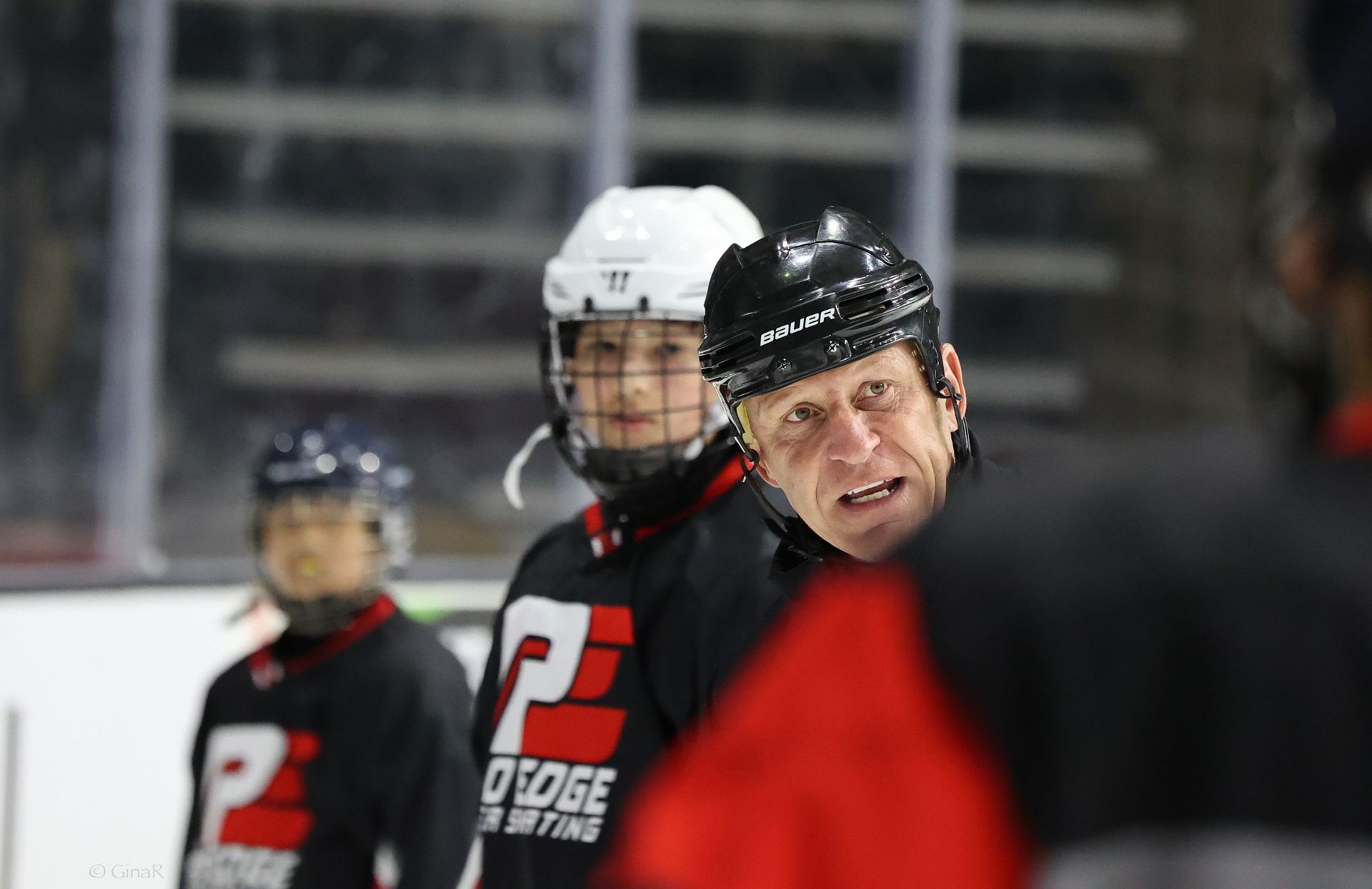 A group of hockey players are standing on the ice.