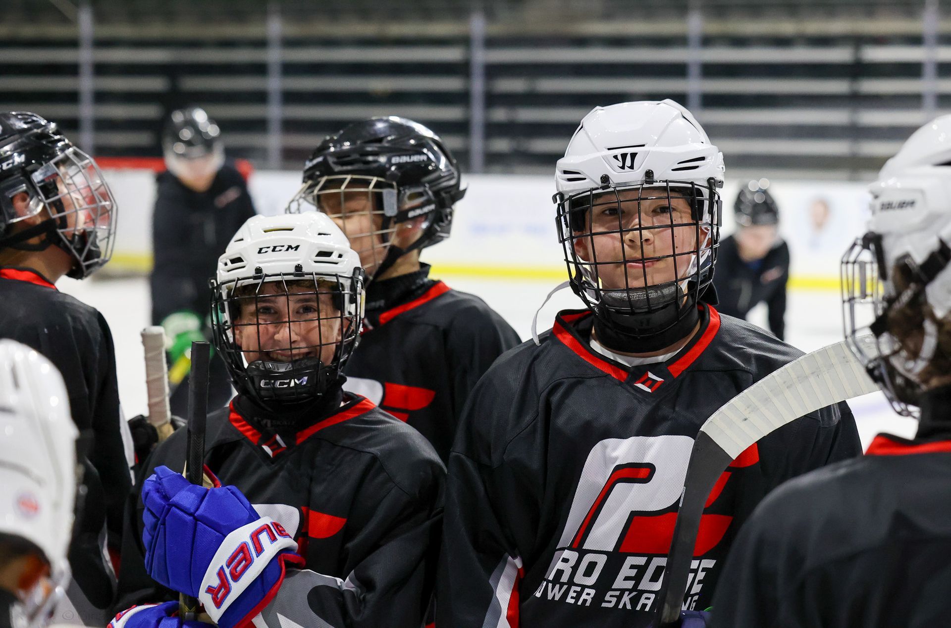 A group of hockey players are standing on the ice.