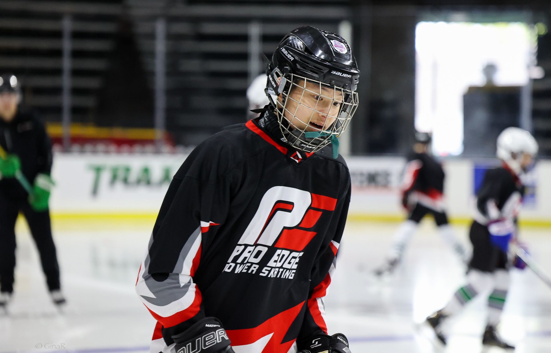 A young boy is playing ice hockey on a rink.