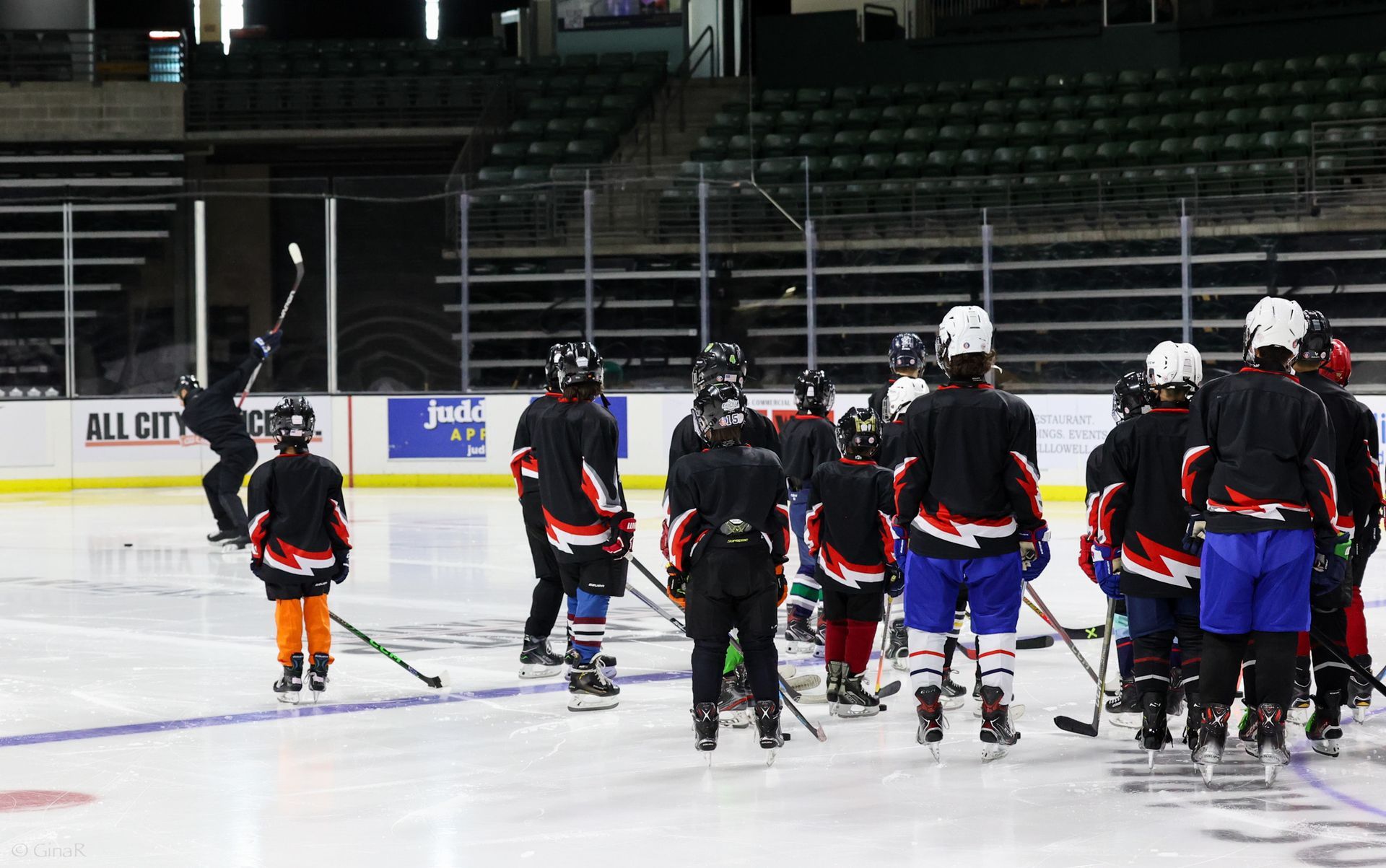 A group of hockey players are walking on the ice.