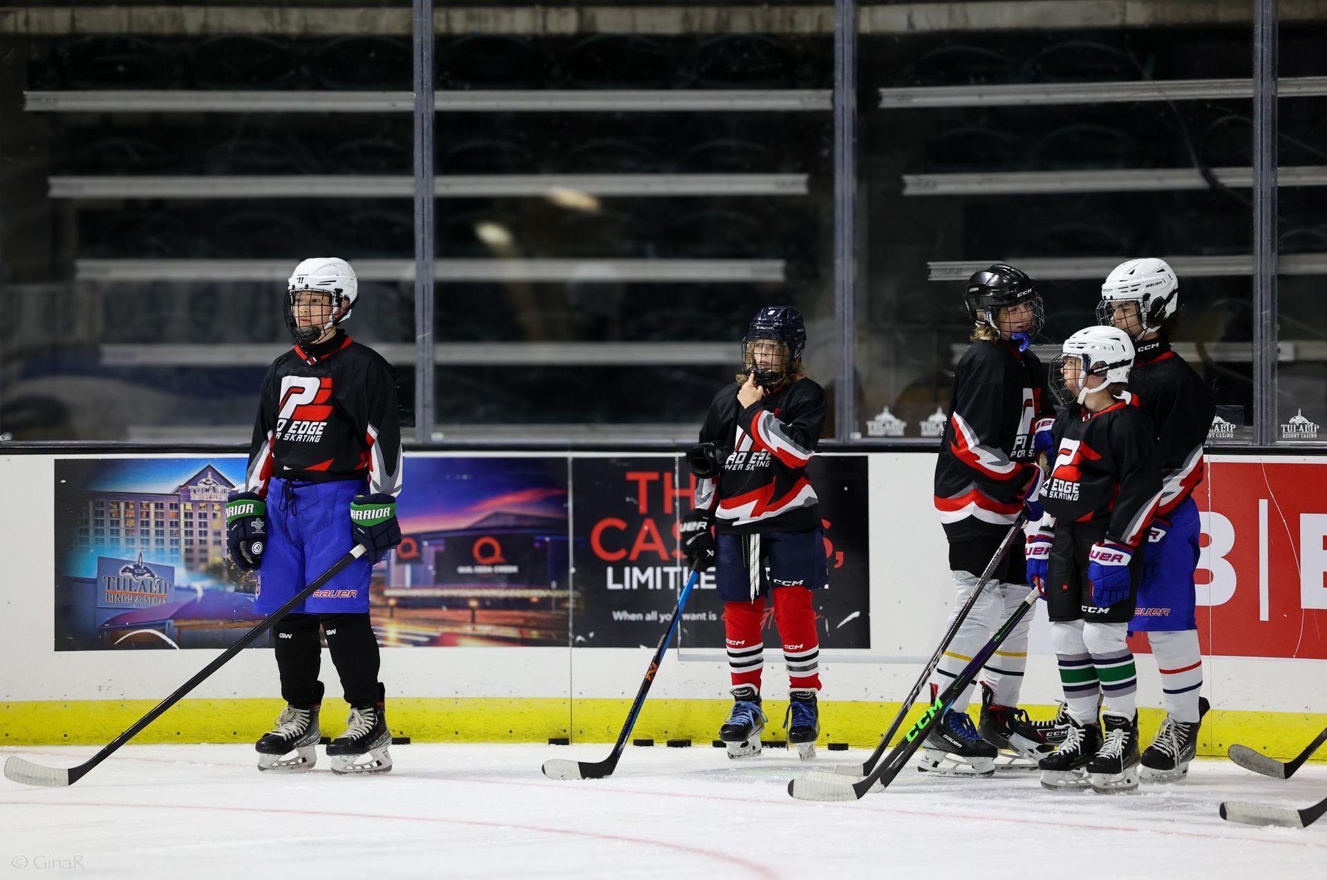 A group of hockey players are standing on the ice.