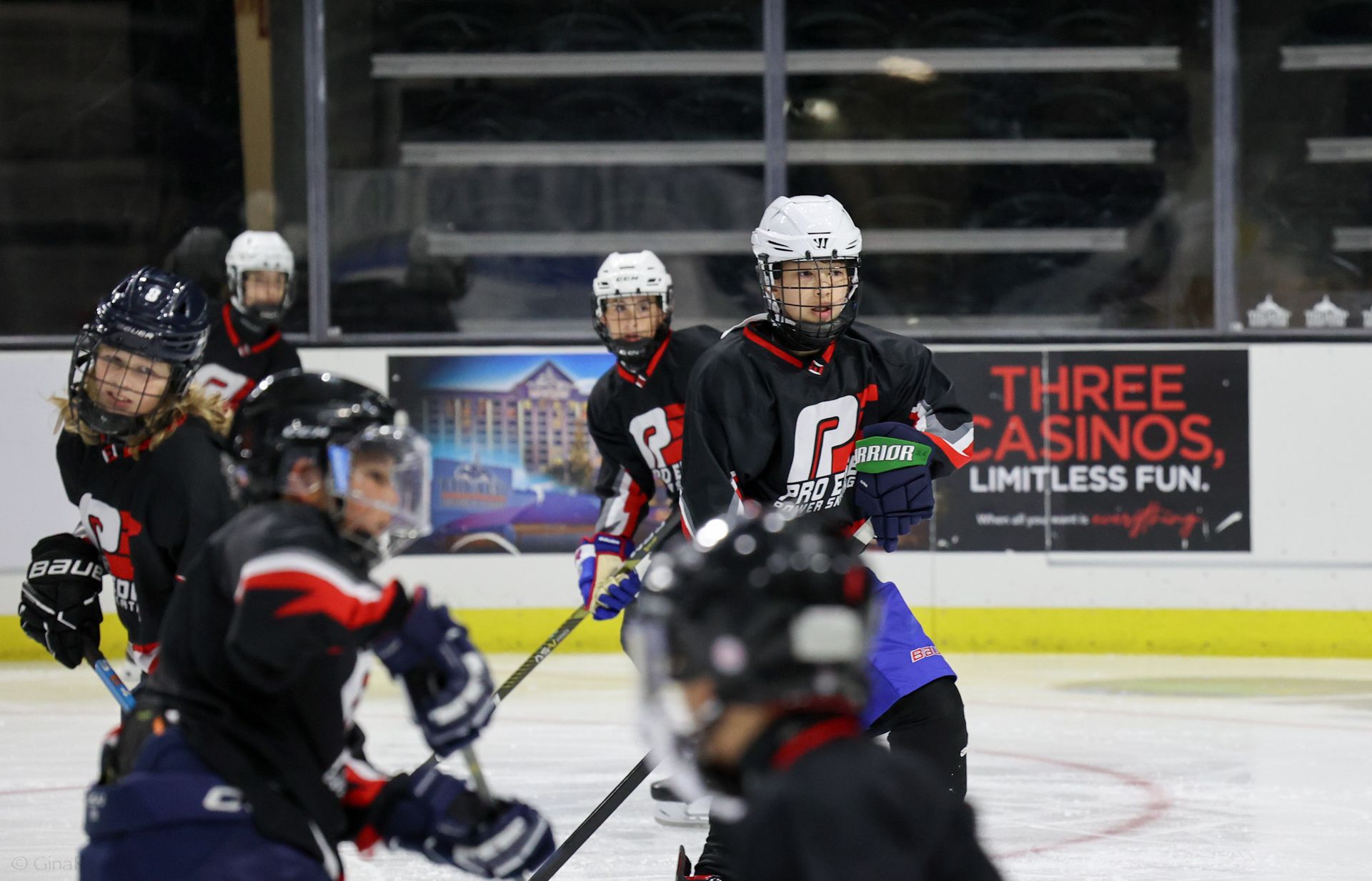 A group of hockey players are playing a game on the ice.