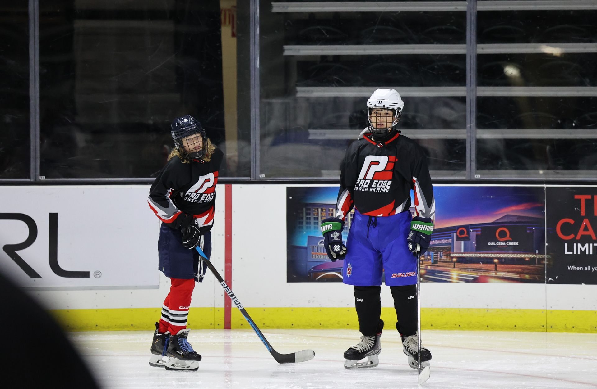 A couple of hockey players are standing on the ice.