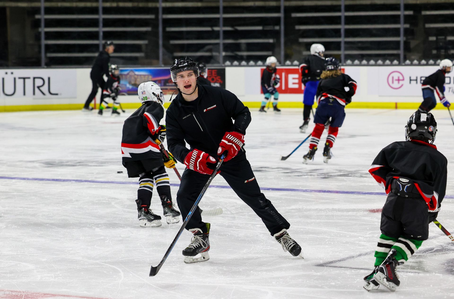 A group of young boys are playing ice hockey on a rink.