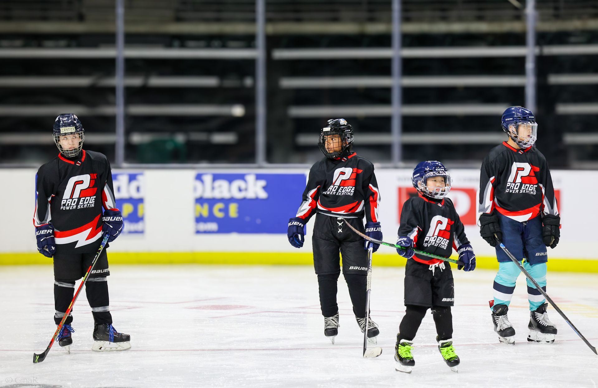 A group of people are playing ice hockey on a rink.