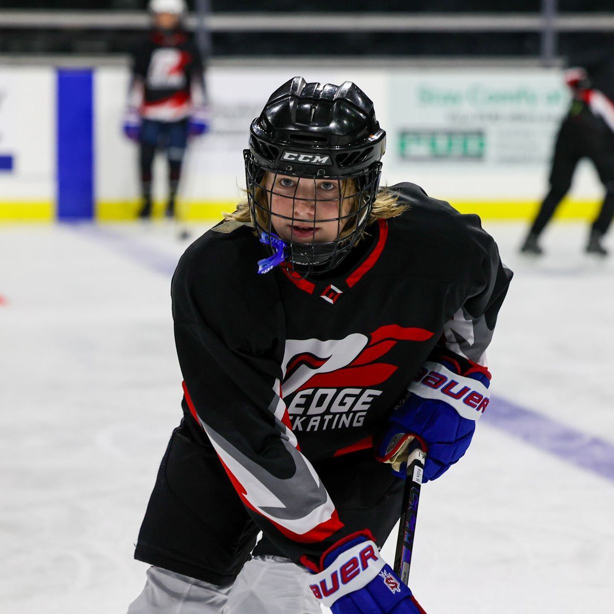 A hockey player with the words pro edge on his jersey