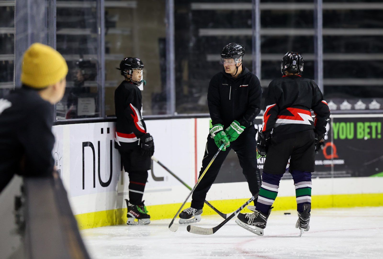 A group of hockey players are practicing on the ice.