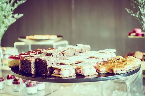 There are many different types of desserts on the table.