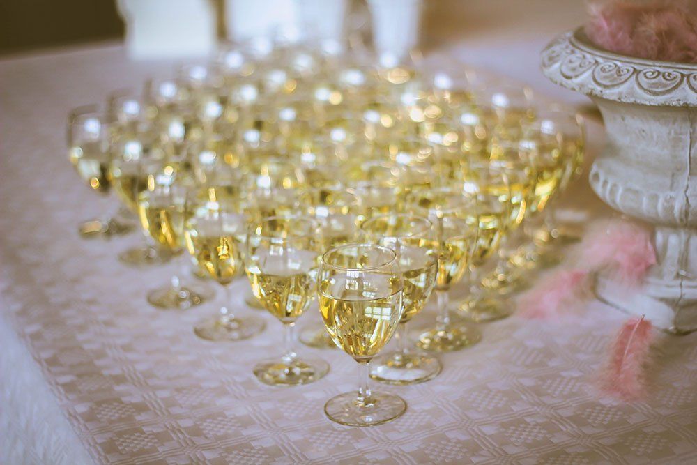 A bunch of champagne glasses sitting on top of a table.