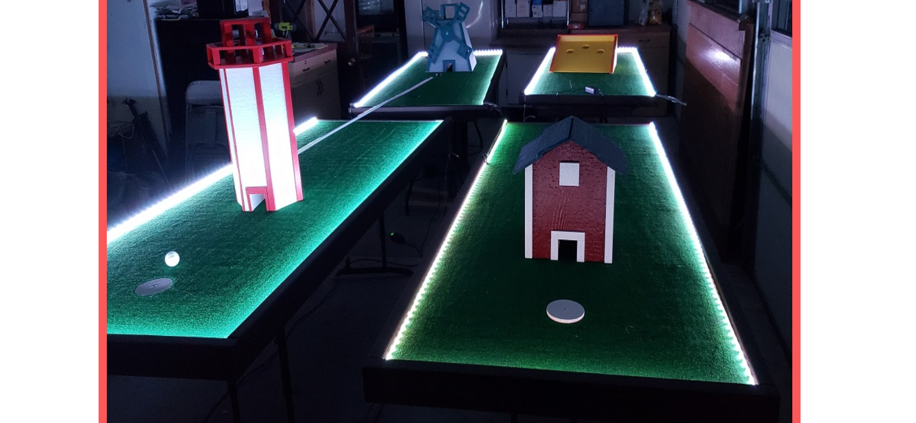 A glow in the dark mini golf table with lights on it