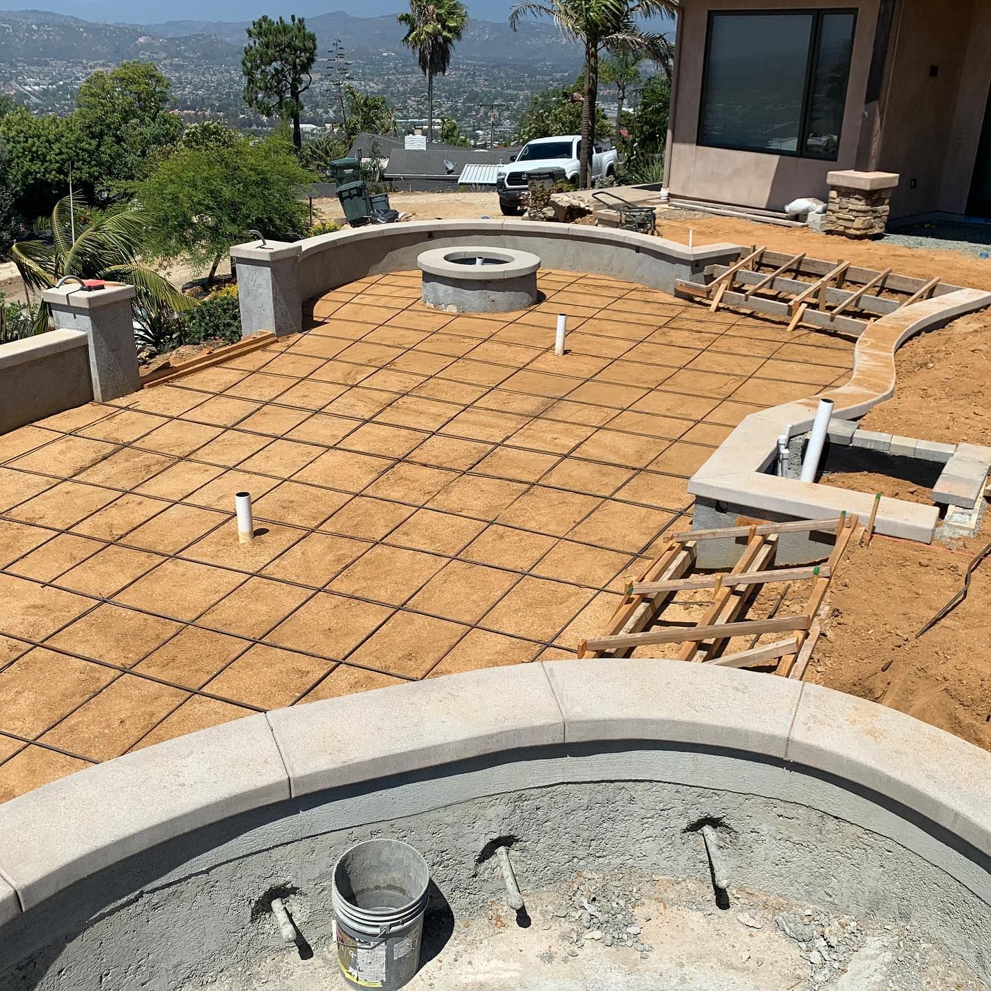 A patio with a fire pit in the middle of it