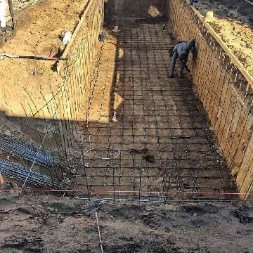 A man is standing in the middle of a construction site.