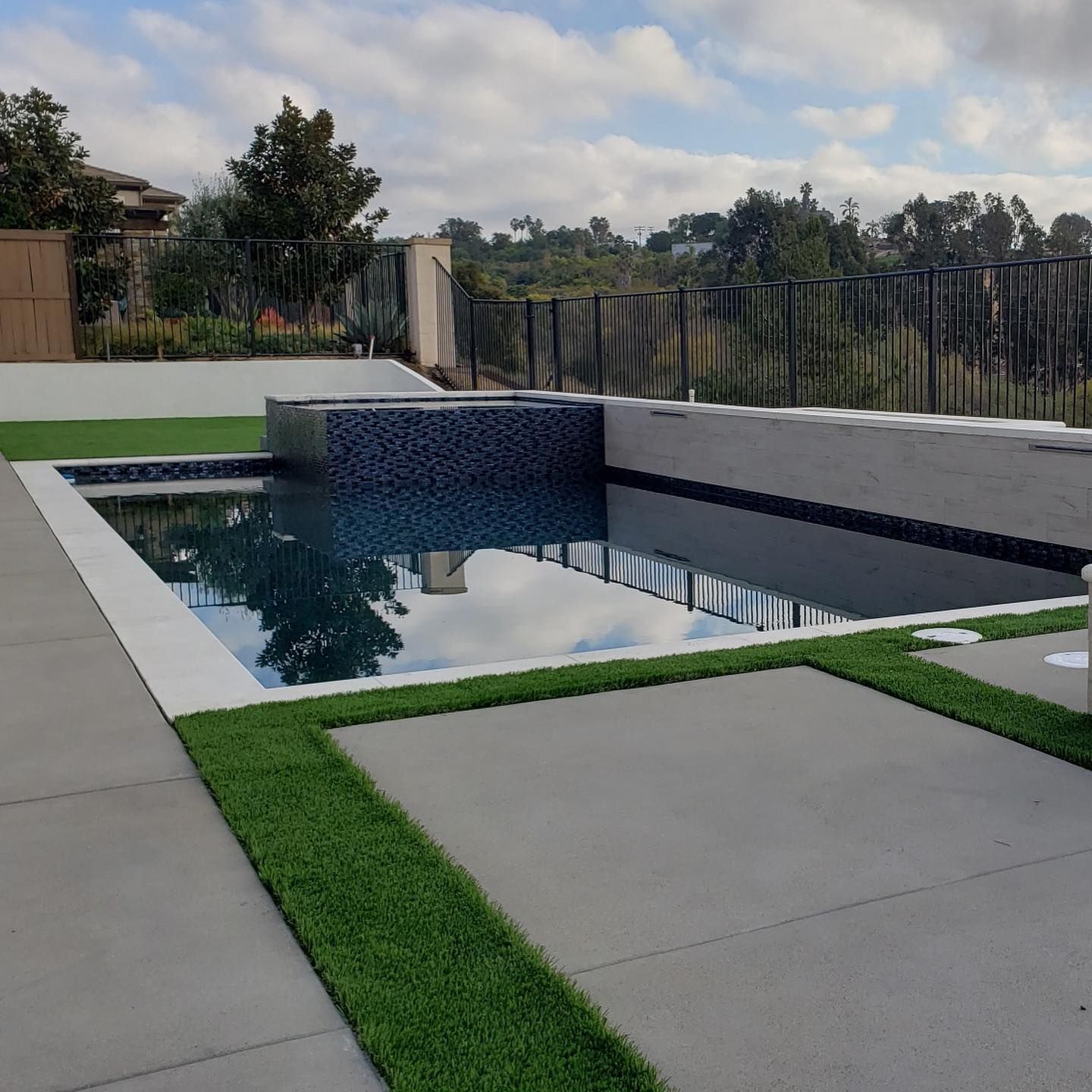 A large swimming pool with a fence around it