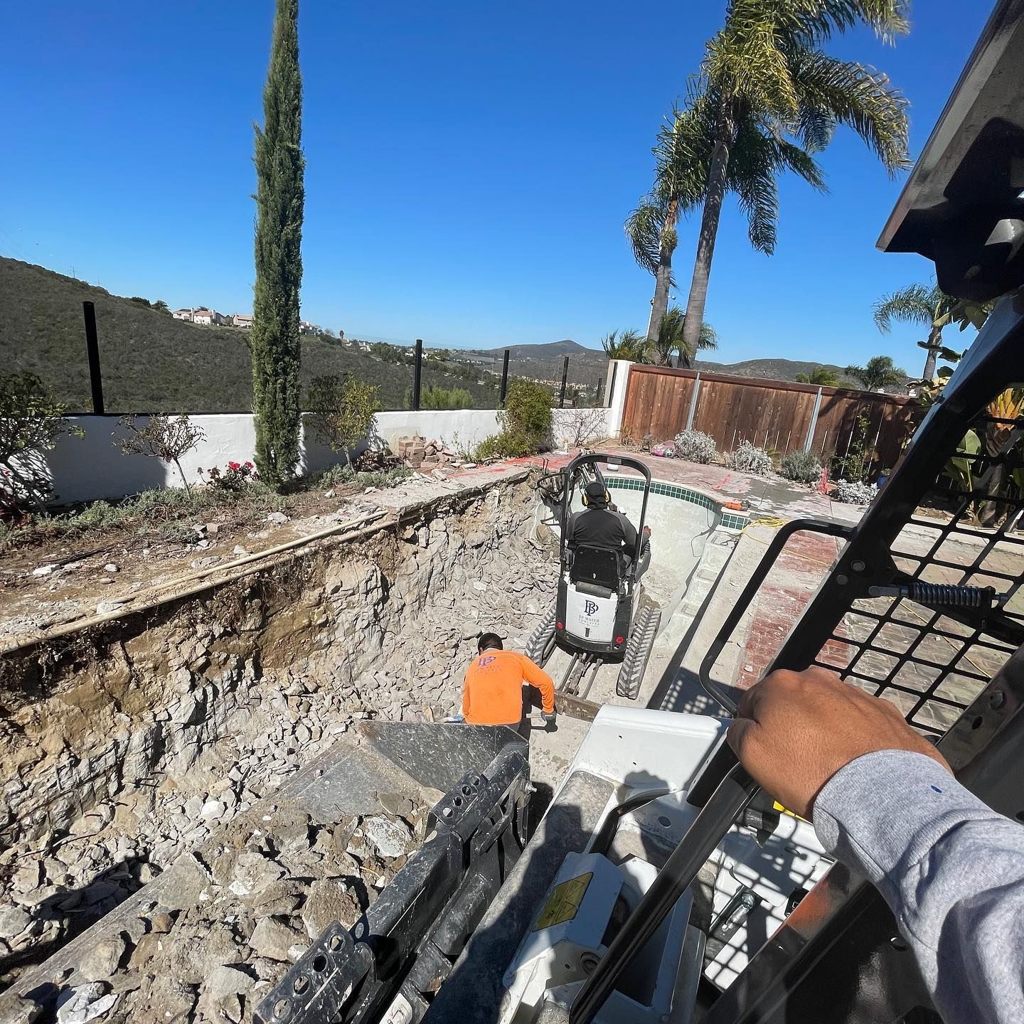 A man is driving a bulldozer on a dirt road