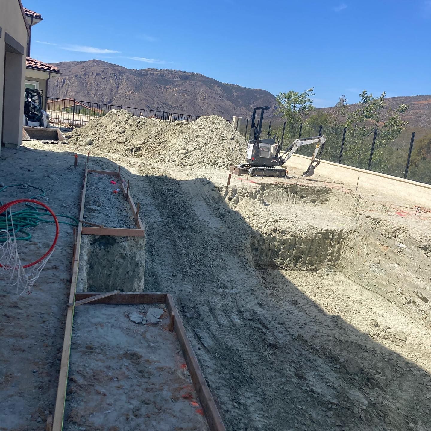 A construction site with a basketball hoop in the middle of it.