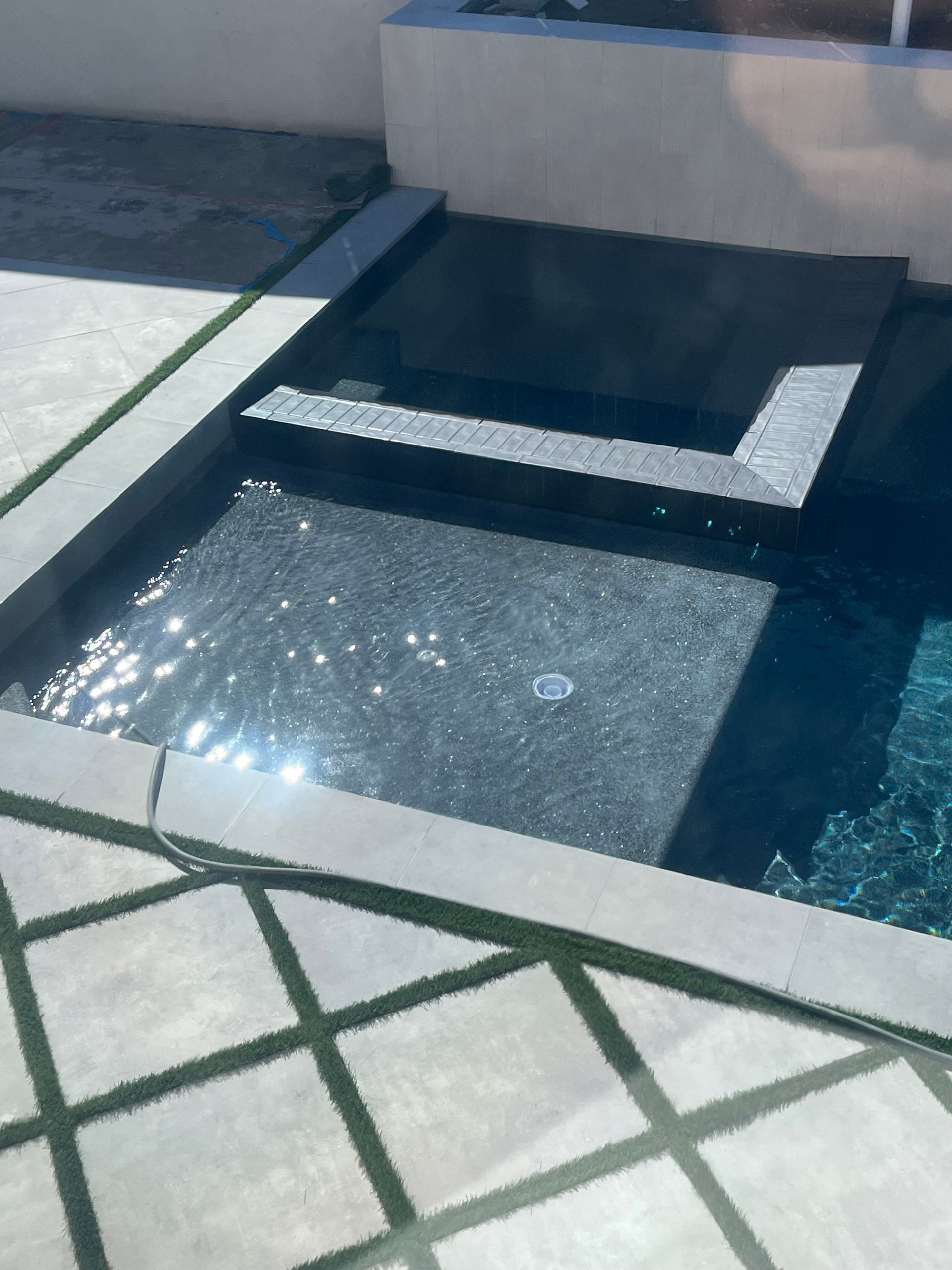 A large swimming pool with a staircase leading to it