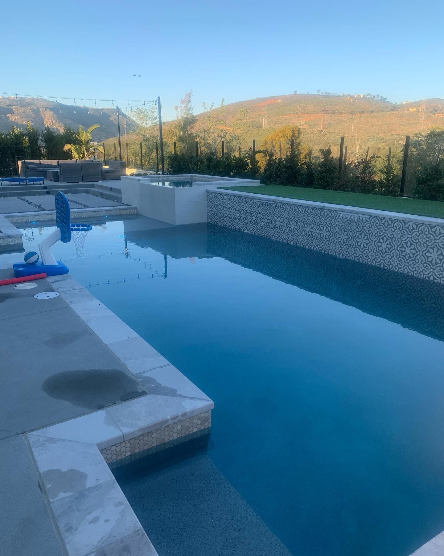 A large swimming pool with mountains in the background.