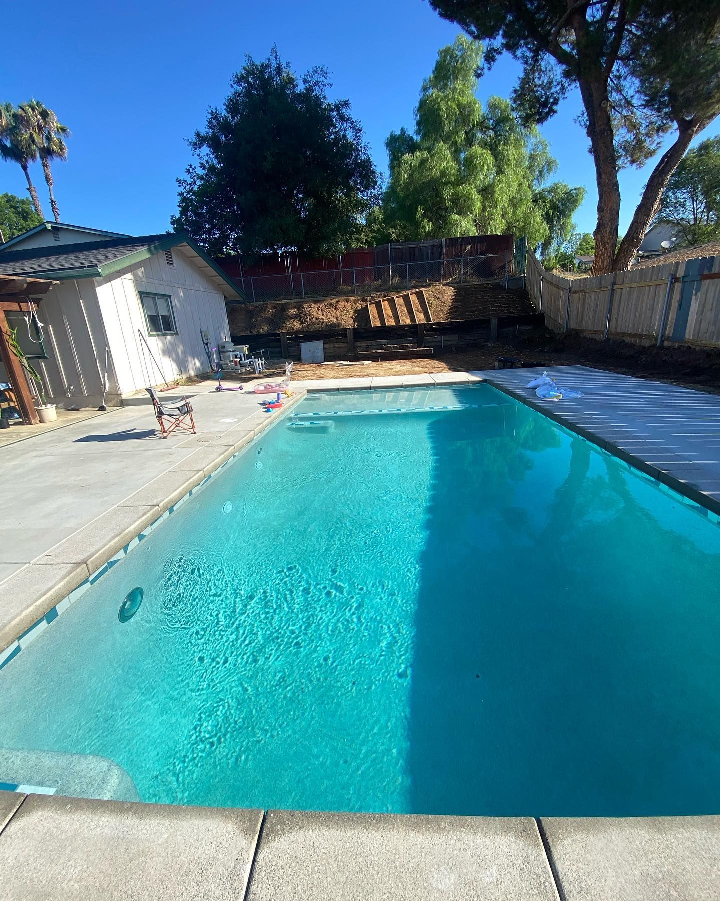 A large swimming pool in the backyard of a house