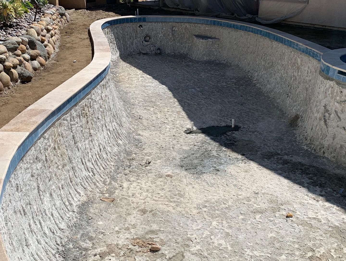 A swimming pool that is empty and needs to be filled with water.