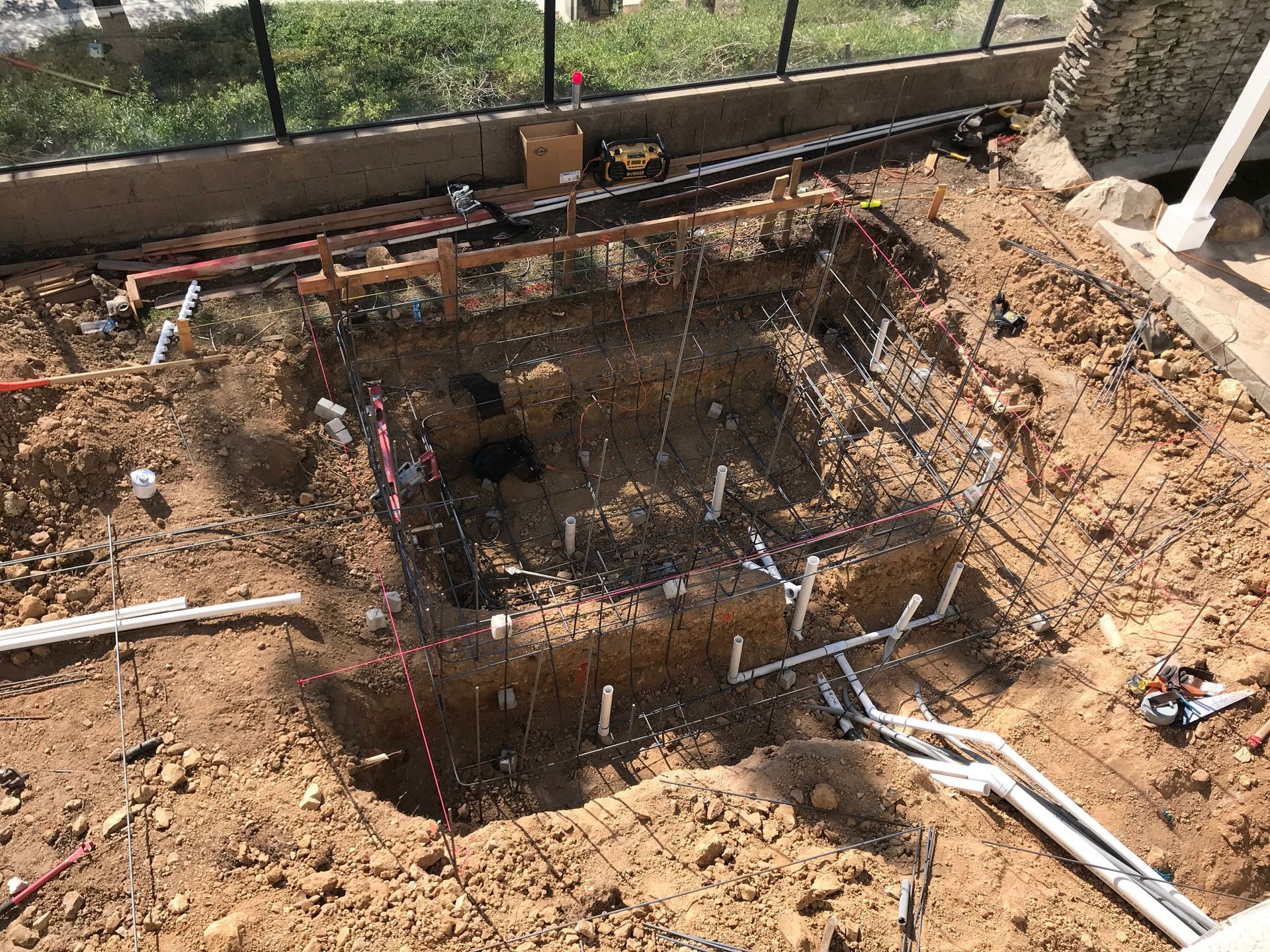 A large hole in the ground with a lot of electrical wires coming out of it.