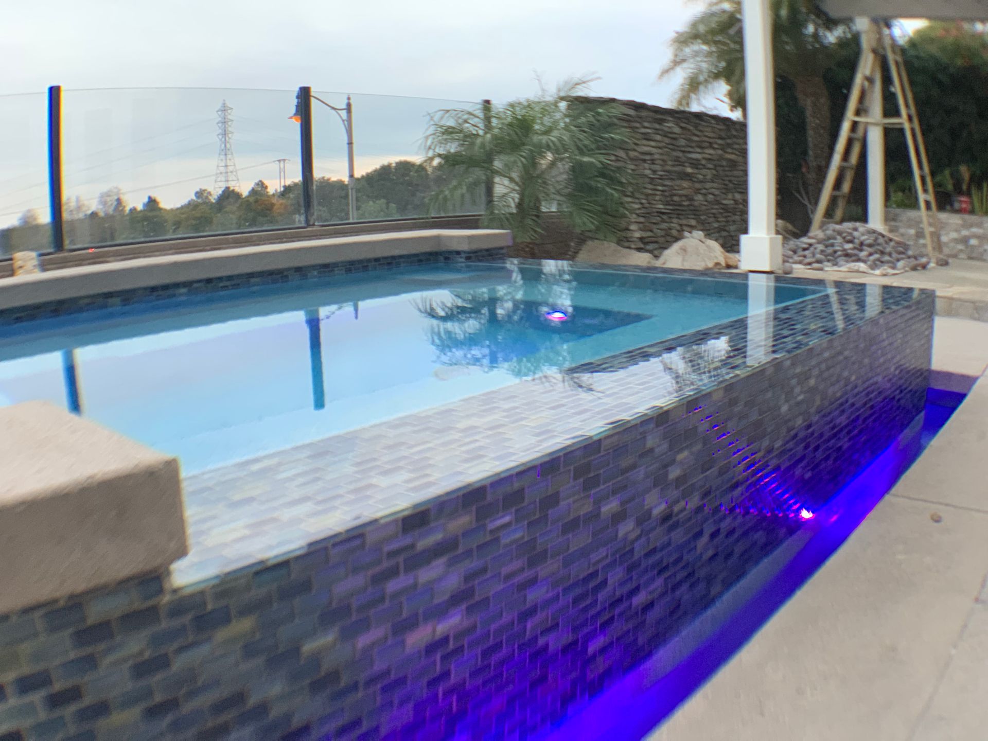 A large swimming pool with a ladder in the background.