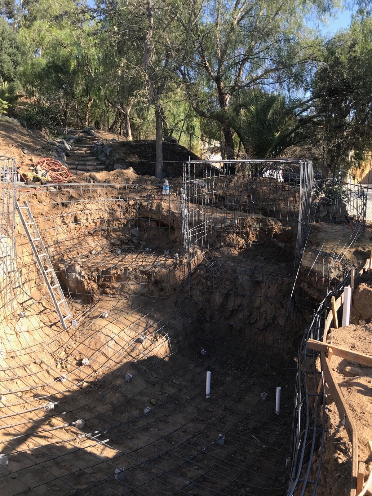 A large hole in the ground with a fence around it.