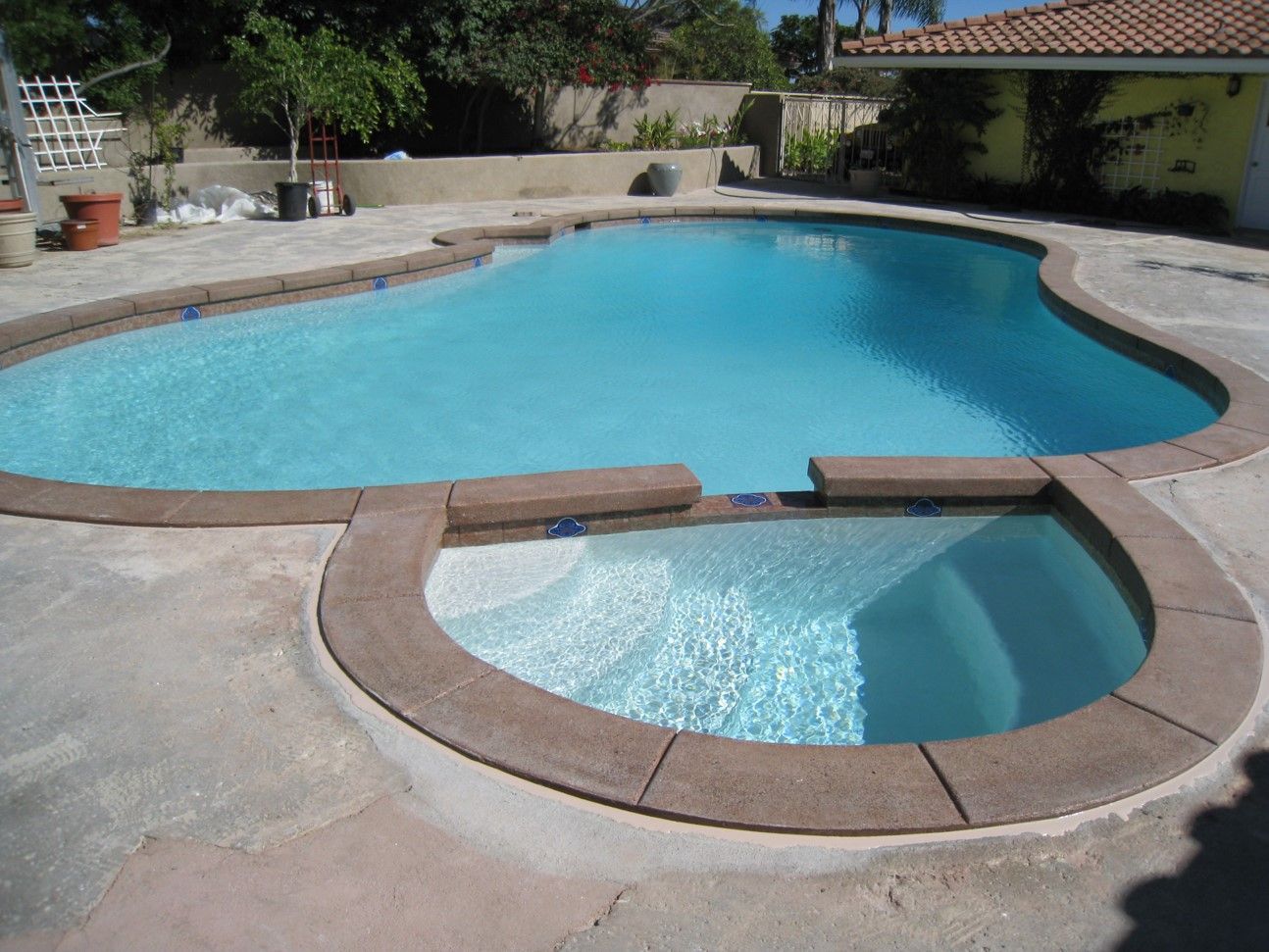 A large swimming pool with a smaller pool in the middle