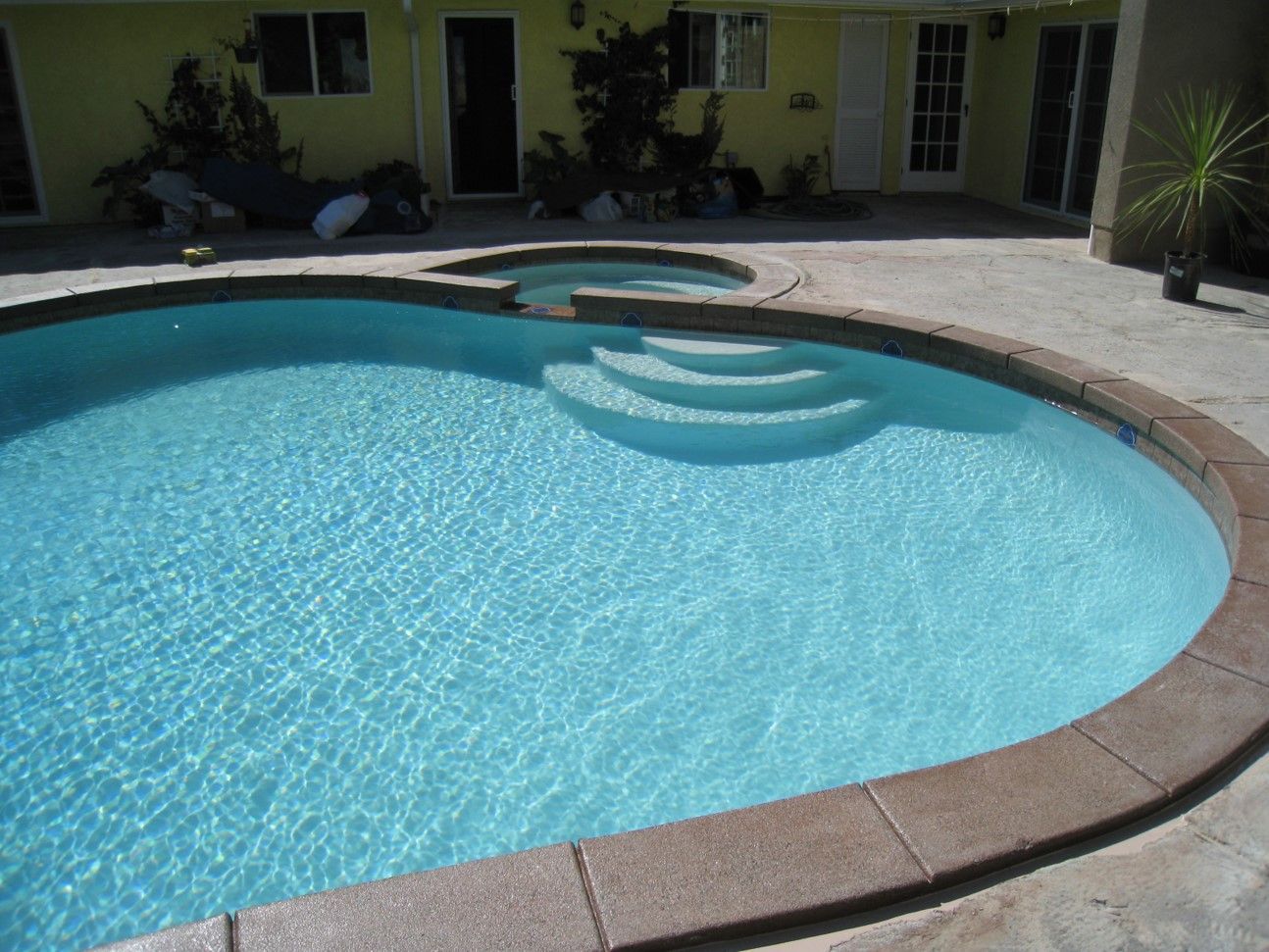 A large swimming pool with stairs leading to it