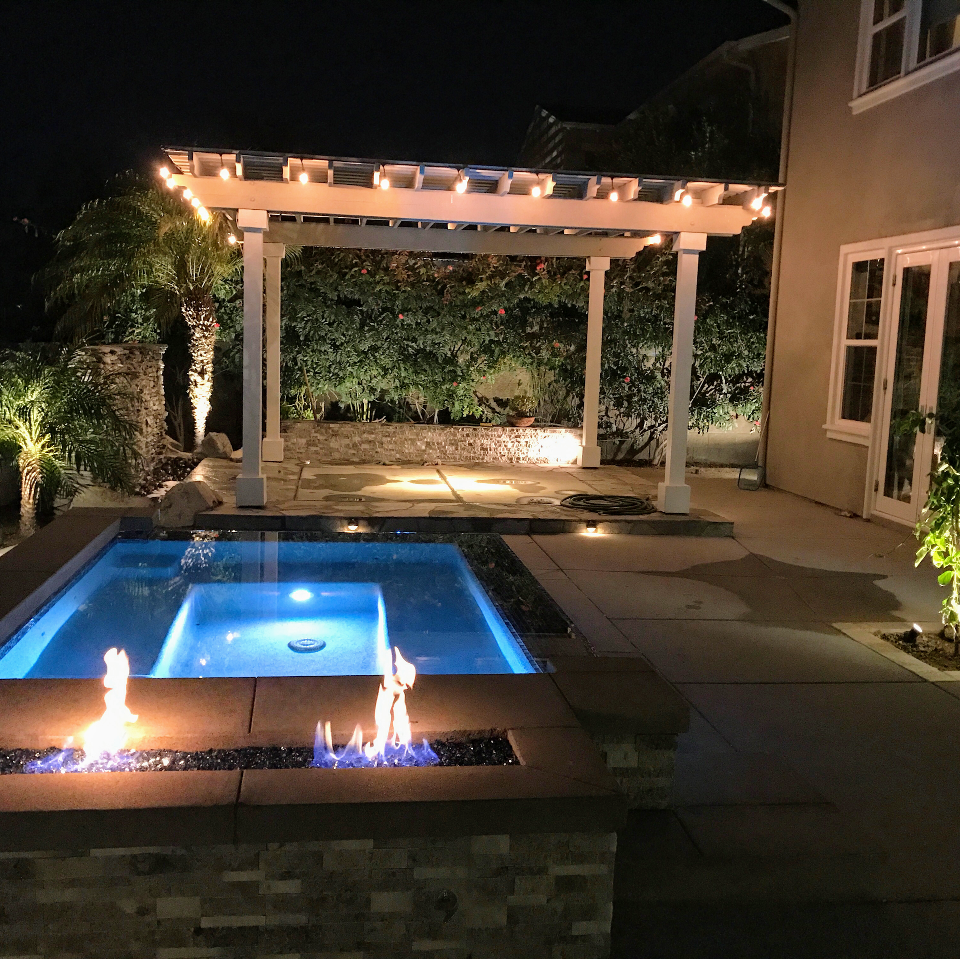 A large swimming pool is lit up at night
