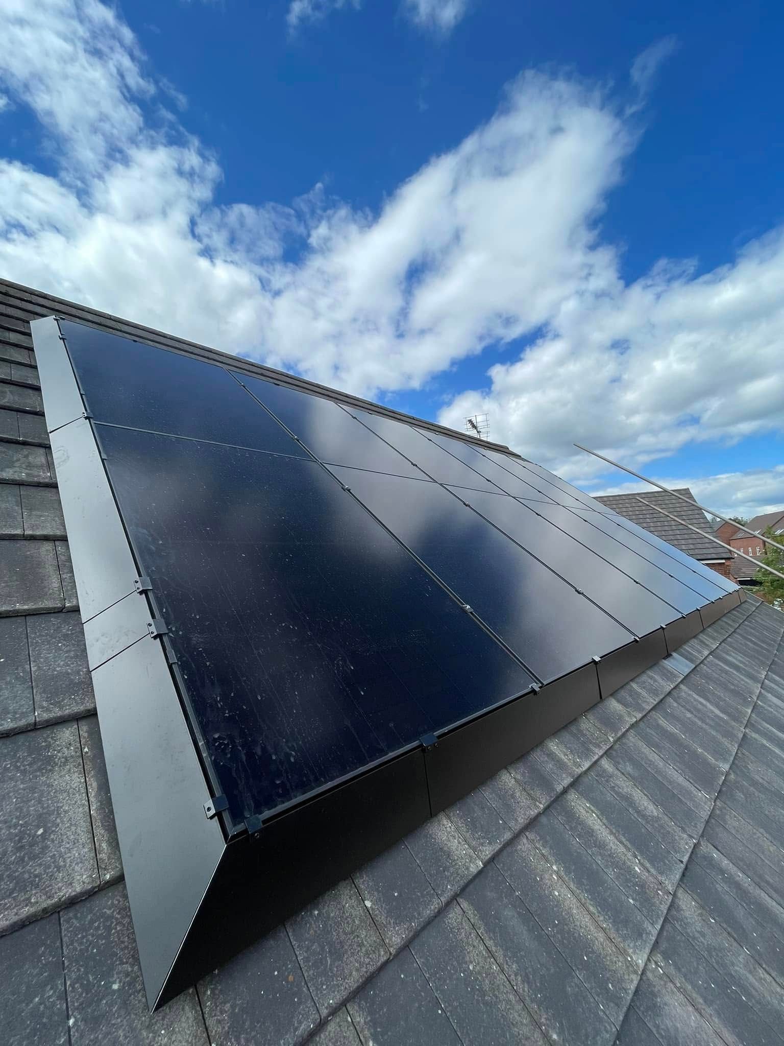 A row of solar panels are sitting on top of a roof.