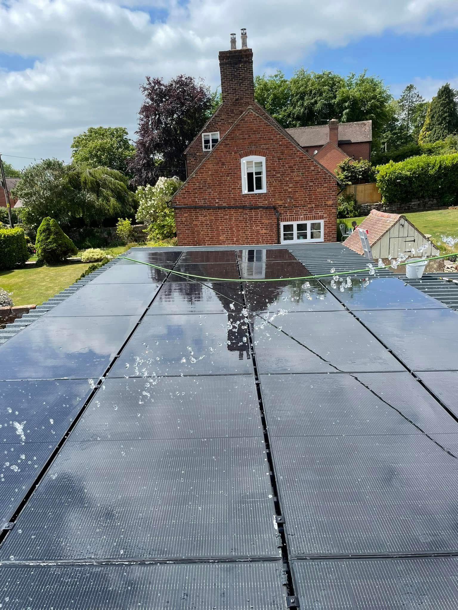 A man is working on a solar panel on the roof of a building.