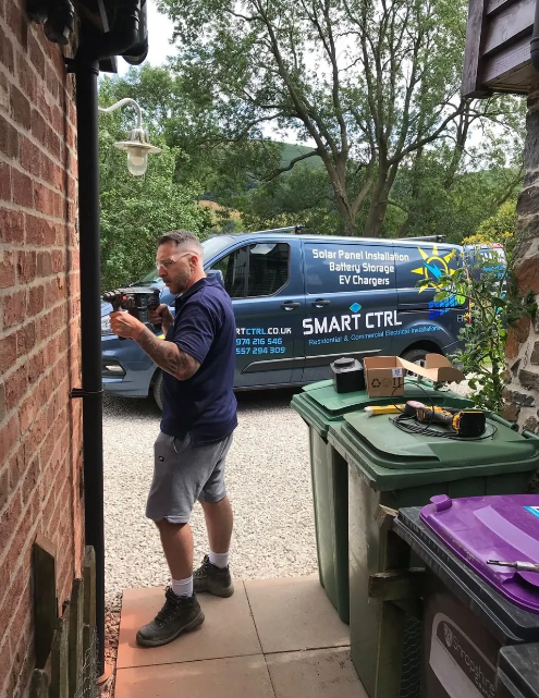 A man is standing in front of a smart ctrl van
