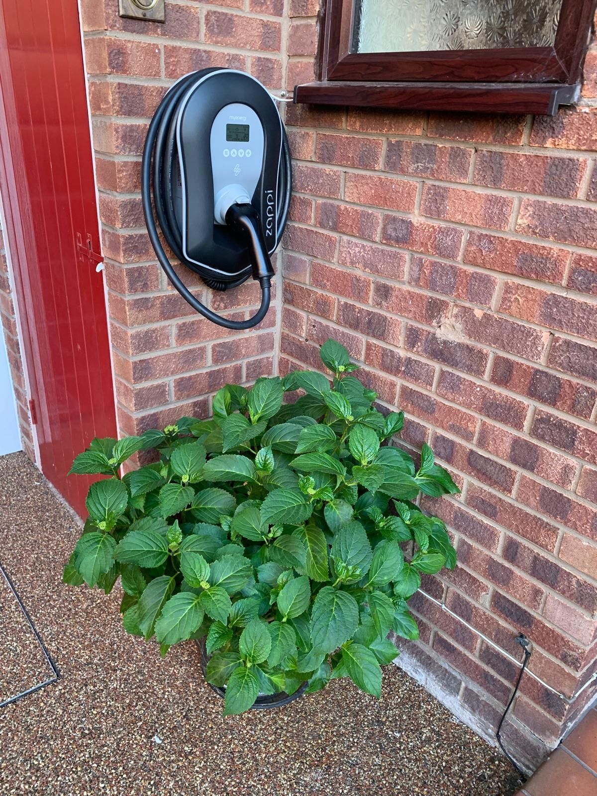 EV Charger against brick wall