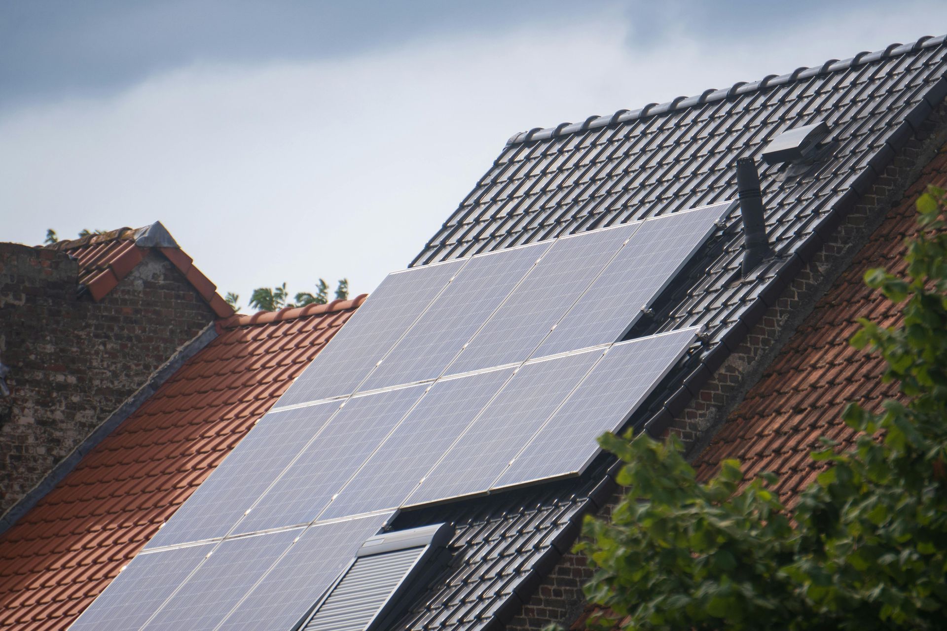 A row of solar panels on the roof of a house