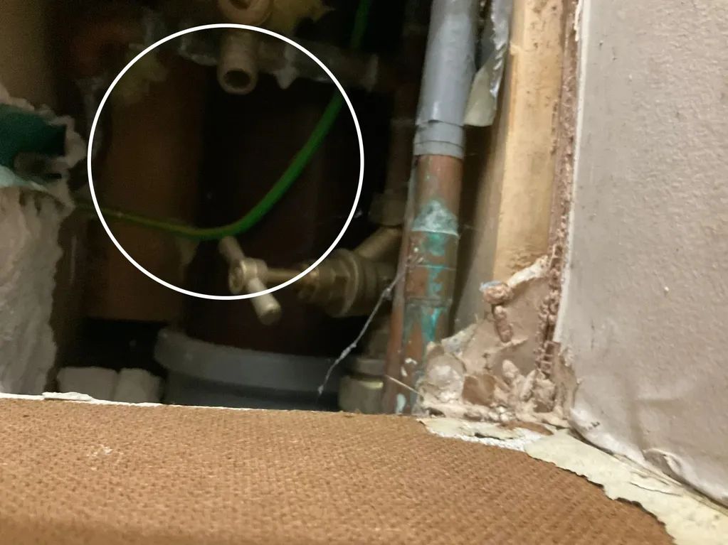 A close up of a pipe in a room with a circle around it.