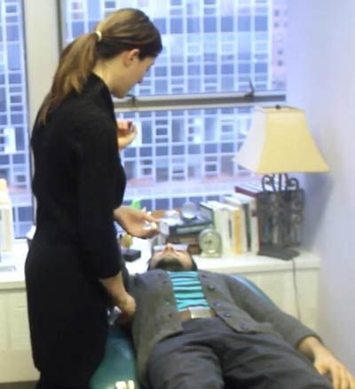 Dr Alicia Armitstead muscle tests a patient suspected of having Microplastic Poisoning