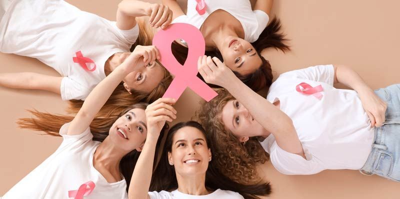 Women with breast cancer ribbons celebrating Healing After Cancer 